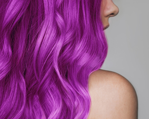 close up of wavy vibrant purple hair showcasing style and color trends
